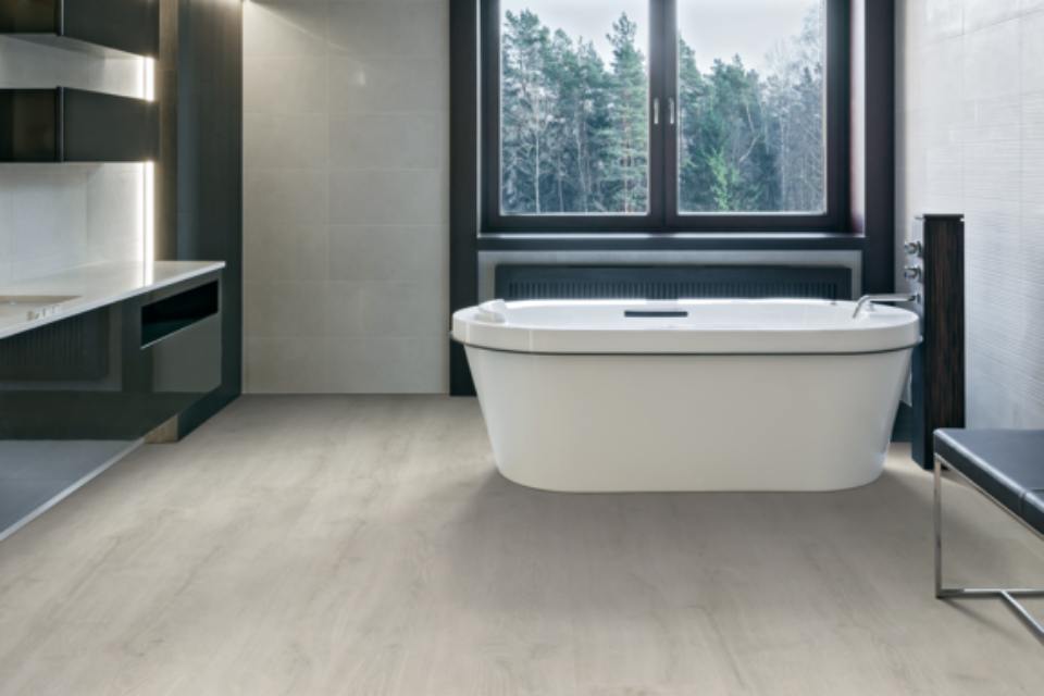 a residential bathroom with luxury vinyl waterproof scratch resistant flooring