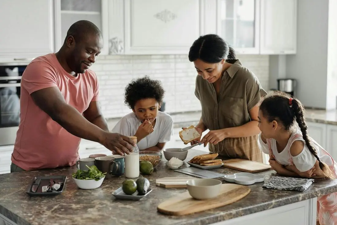 a family preparing breakfast together in their busy home