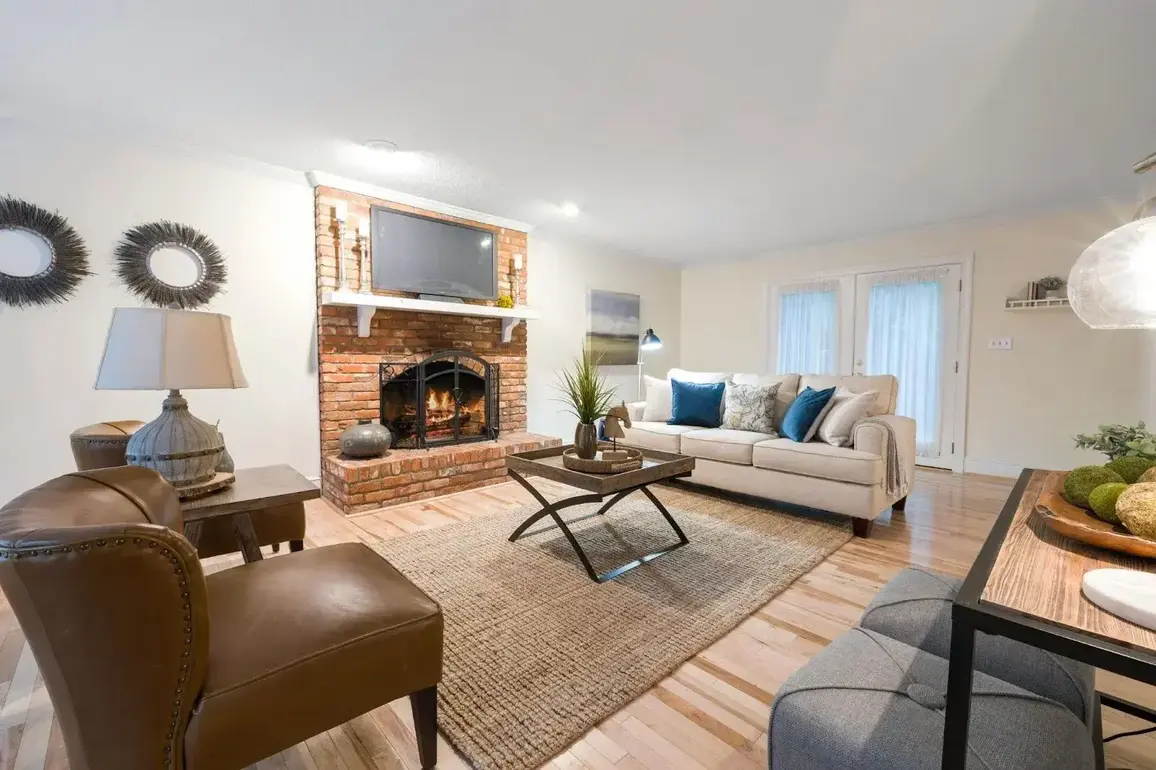 A cozy living room with a lit fireplace during cold weather