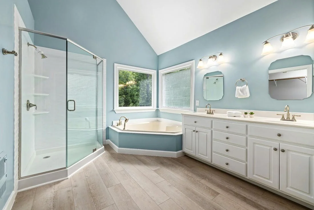 A residential bathroom with waterproof wood flooring.