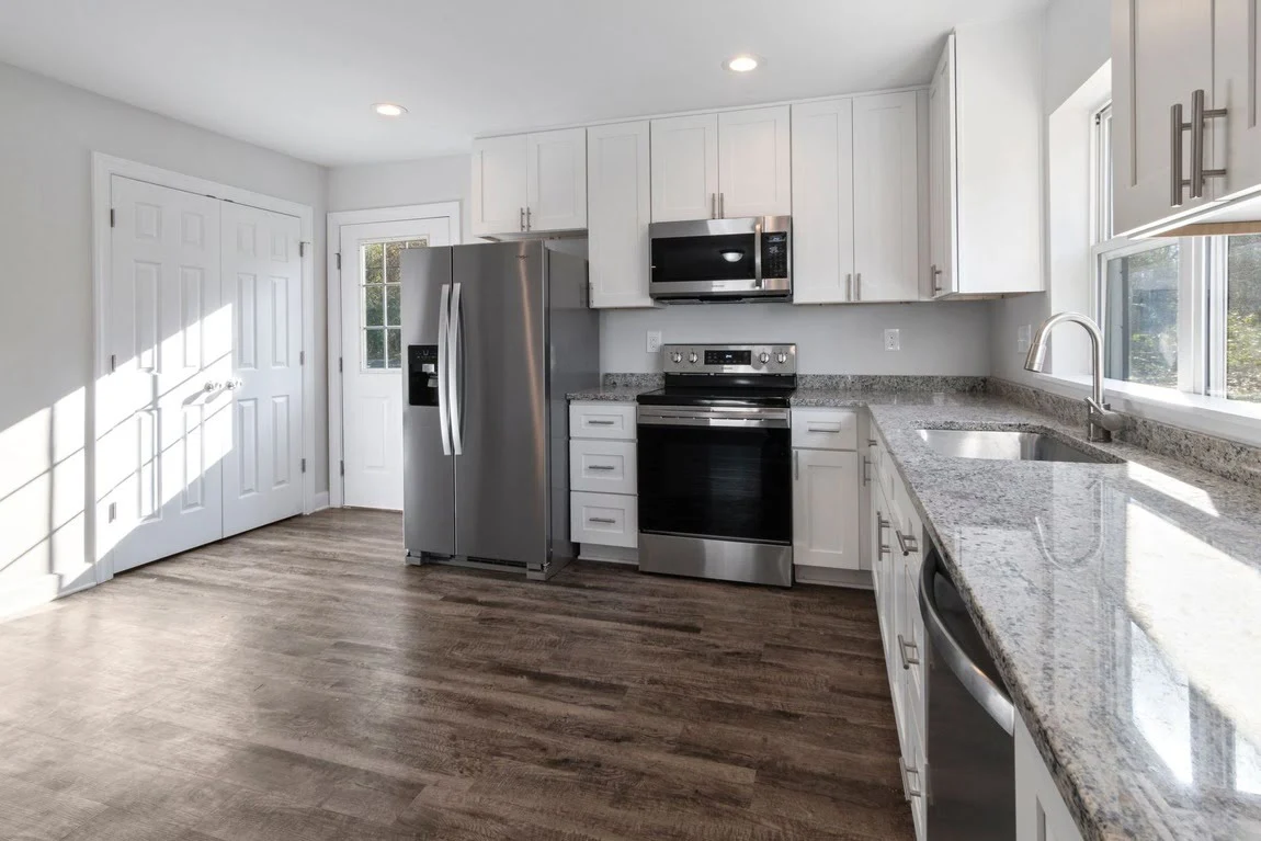 A recently renovated kitchen featuring new durable waterproof flooring.