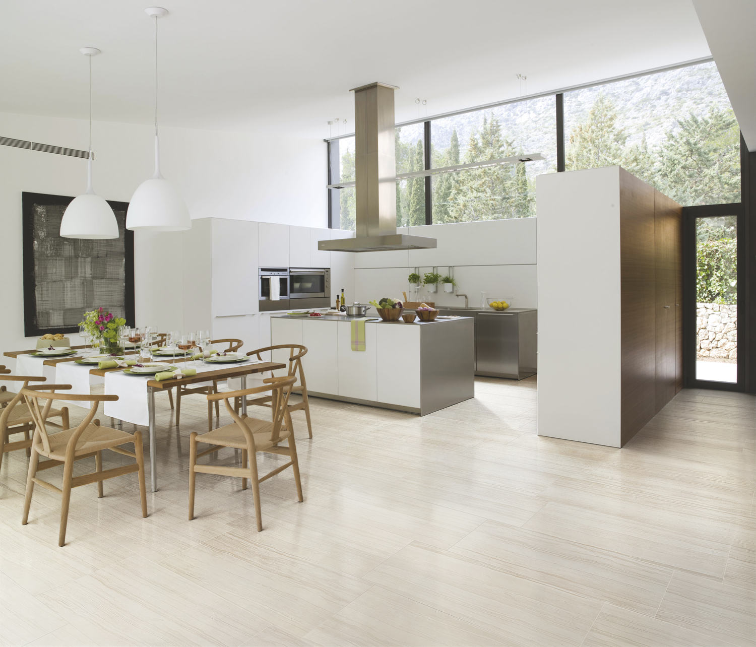Contemporary dining room setting with table, chairs, kitchen area in open layout featuring light-shaded ceramic tile